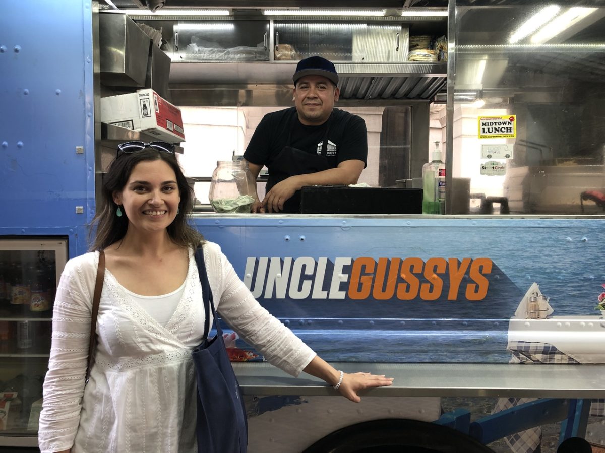 Amanda posing and smiling in front of a food truck
