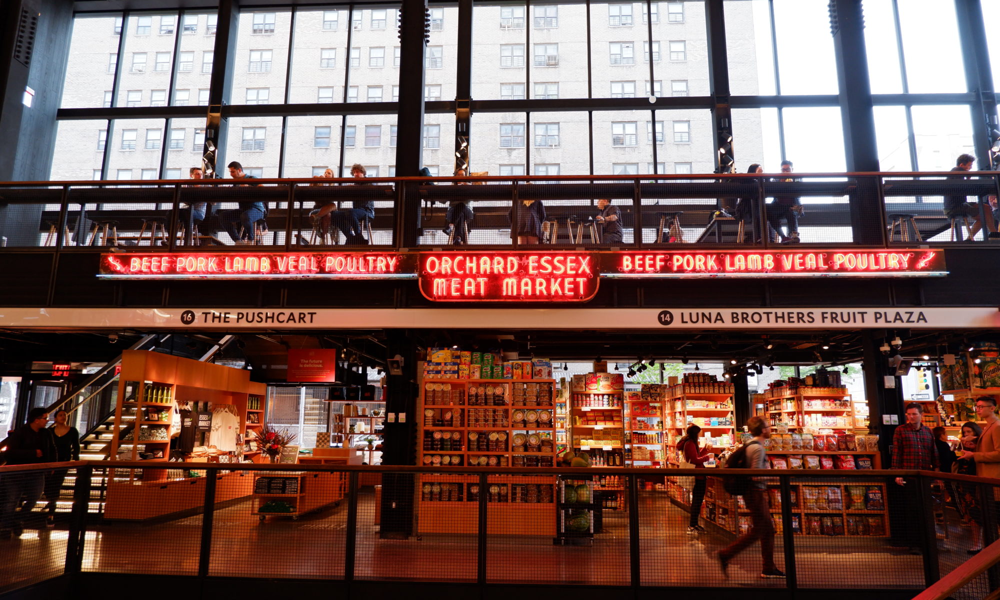 The first and second floors of the Essex Market with a historic neon sign from the Orchard Essex Meat Market