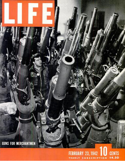 Life Magazine Cover February 23, 1942, showing a worker standing in the middle of large naval guns with the title "Guns for Merchantmen."