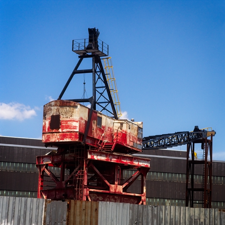 Red Navy Yard crane behind fense