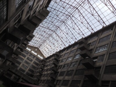 A dramatic look up at the window frames that connect two sides of the Brooklyn Army Terminal's gigantic and imposing Building B, made of poured concrete with off-set balconies