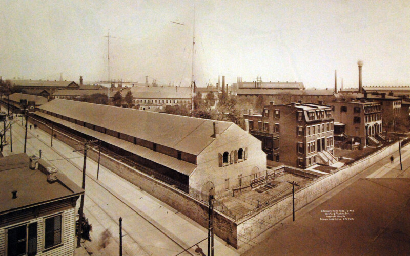 Photo showing the Timber Shed in the forground with Admirals Row to the right and the Brooklyn Navy Yard behind.