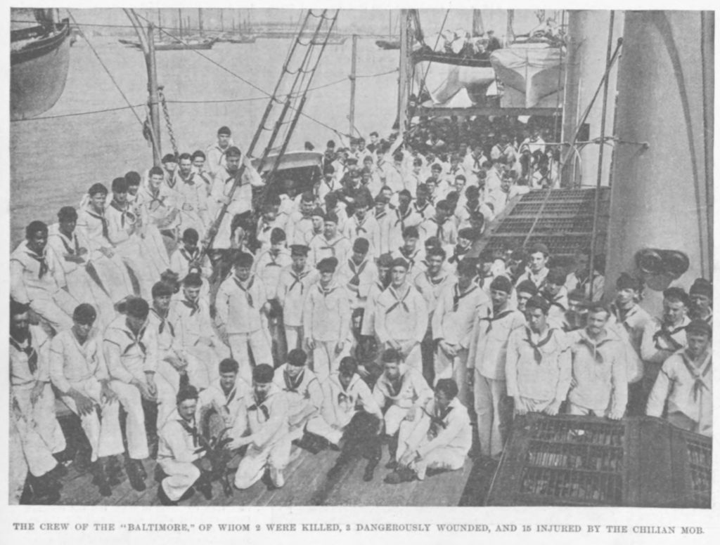 Black and white photo of sailors in white uniforms on the deck of a ship